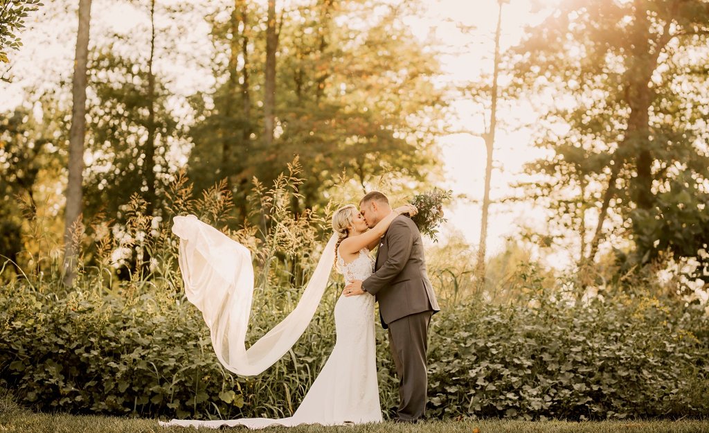 Wedding Bride and Groom kiss yard